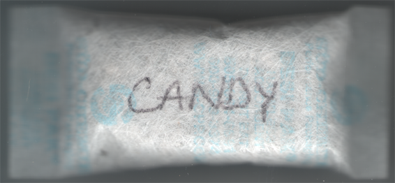 Silica gel packet with 'candy' written on it.